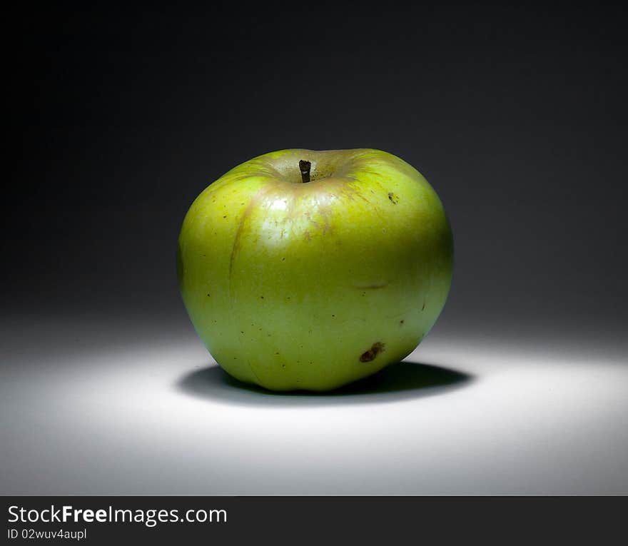 Green apple in the dark room