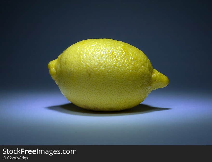 Yellow natural lemon on blue background