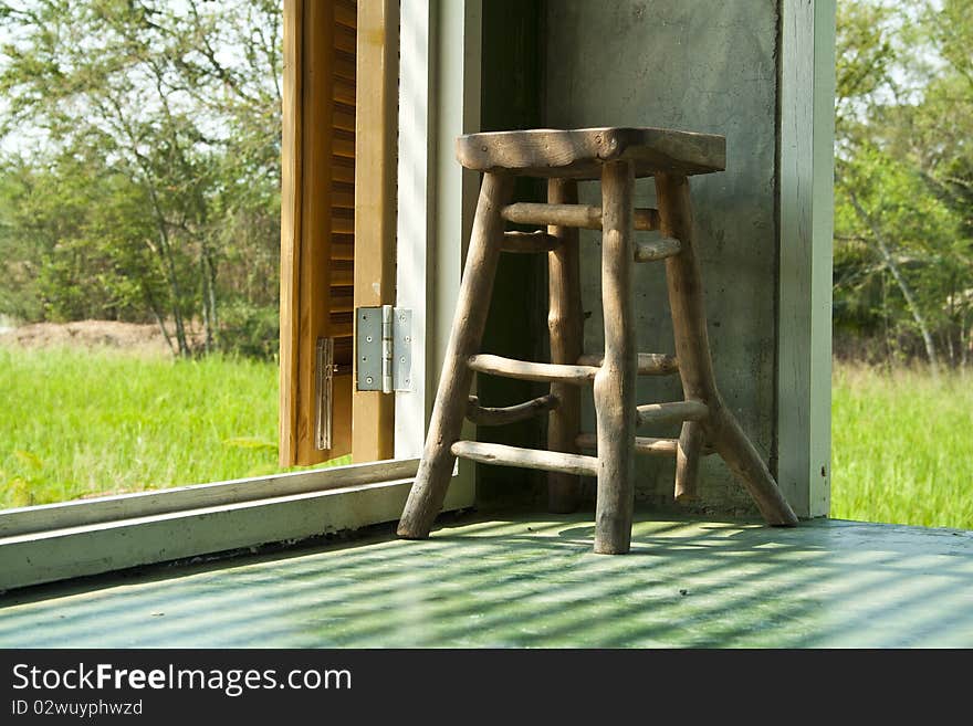 The graphic of shadow and highlight on a chair with rice field background.