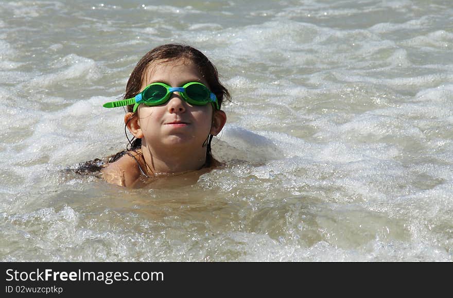 Beautiful, funny, girl seven years at sea. There is no front teeth. She is wearing glasses for swimming. Beautiful, funny, girl seven years at sea. There is no front teeth. She is wearing glasses for swimming