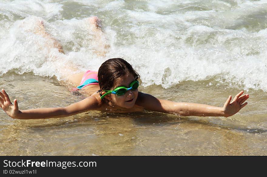 Beautiful, funny, girl seven years at sea. There is no front teeth. She is wearing glasses for swimming. Beautiful, funny, girl seven years at sea. There is no front teeth. She is wearing glasses for swimming