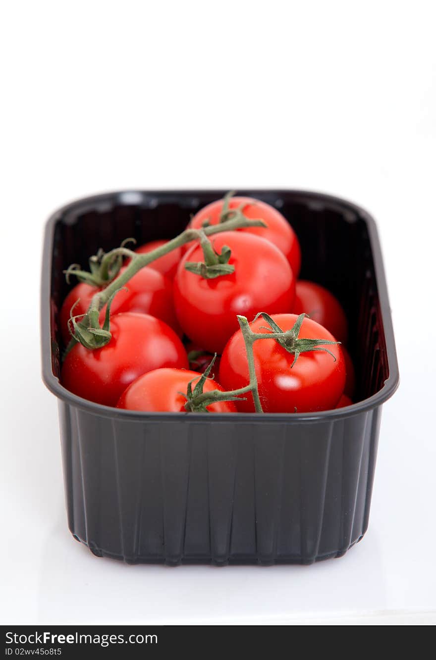 Fresh cherry tomato in box on white background