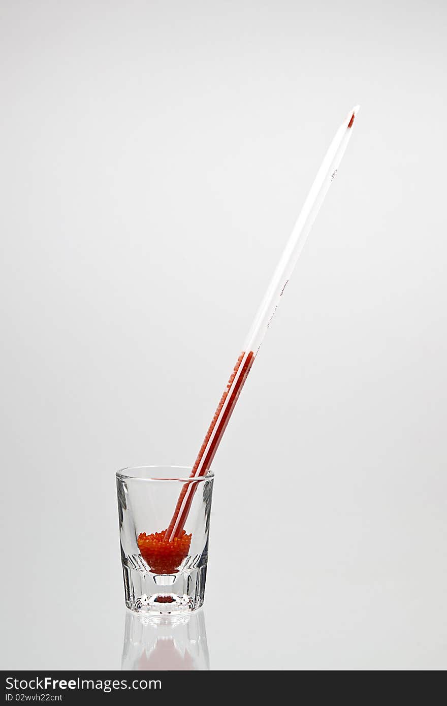 A granulated candy straw inside of a glass