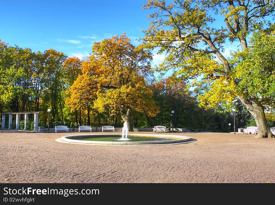 Autumn park with benches and fountain. Autumn park with benches and fountain