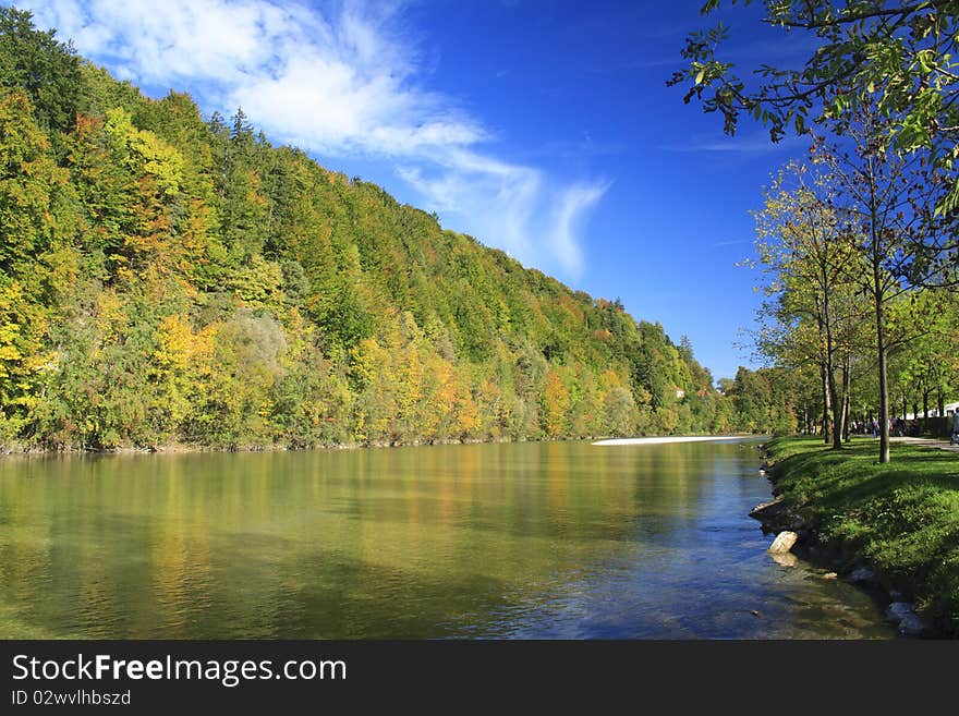 River in autumn with colorful trees and blue sky