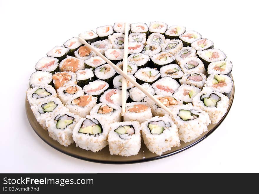 Collection of different rolls served on the round plate. Collection of different rolls served on the round plate