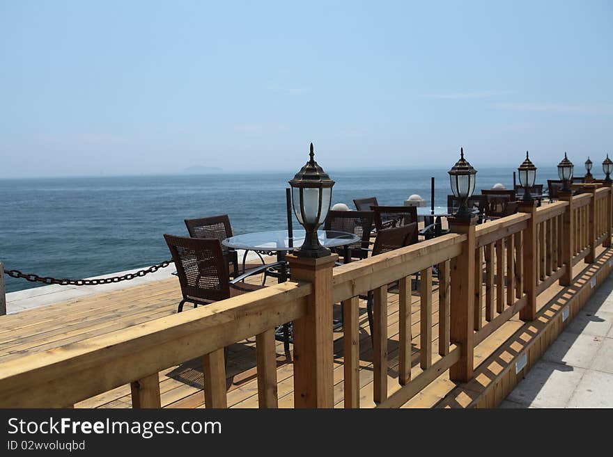 A row of leisure chairs and table at beach