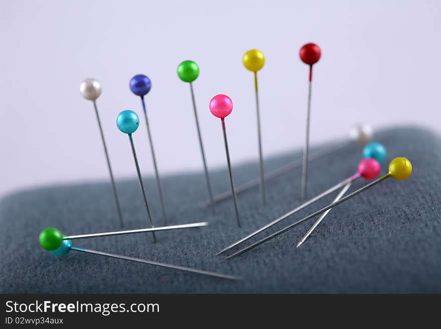 Needle with colorful head with a white background