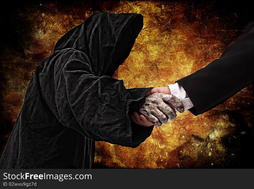 Business handshake with reaper, fire background