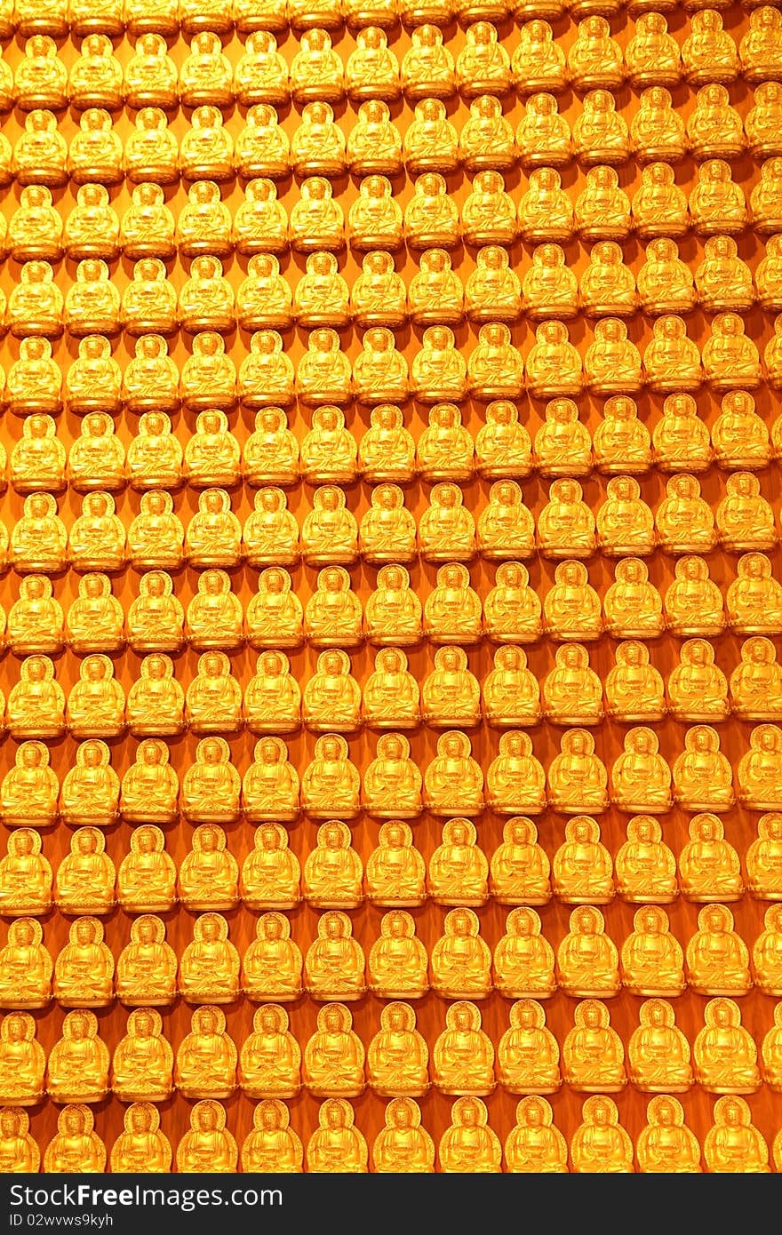 Golden buddha on wooden wall