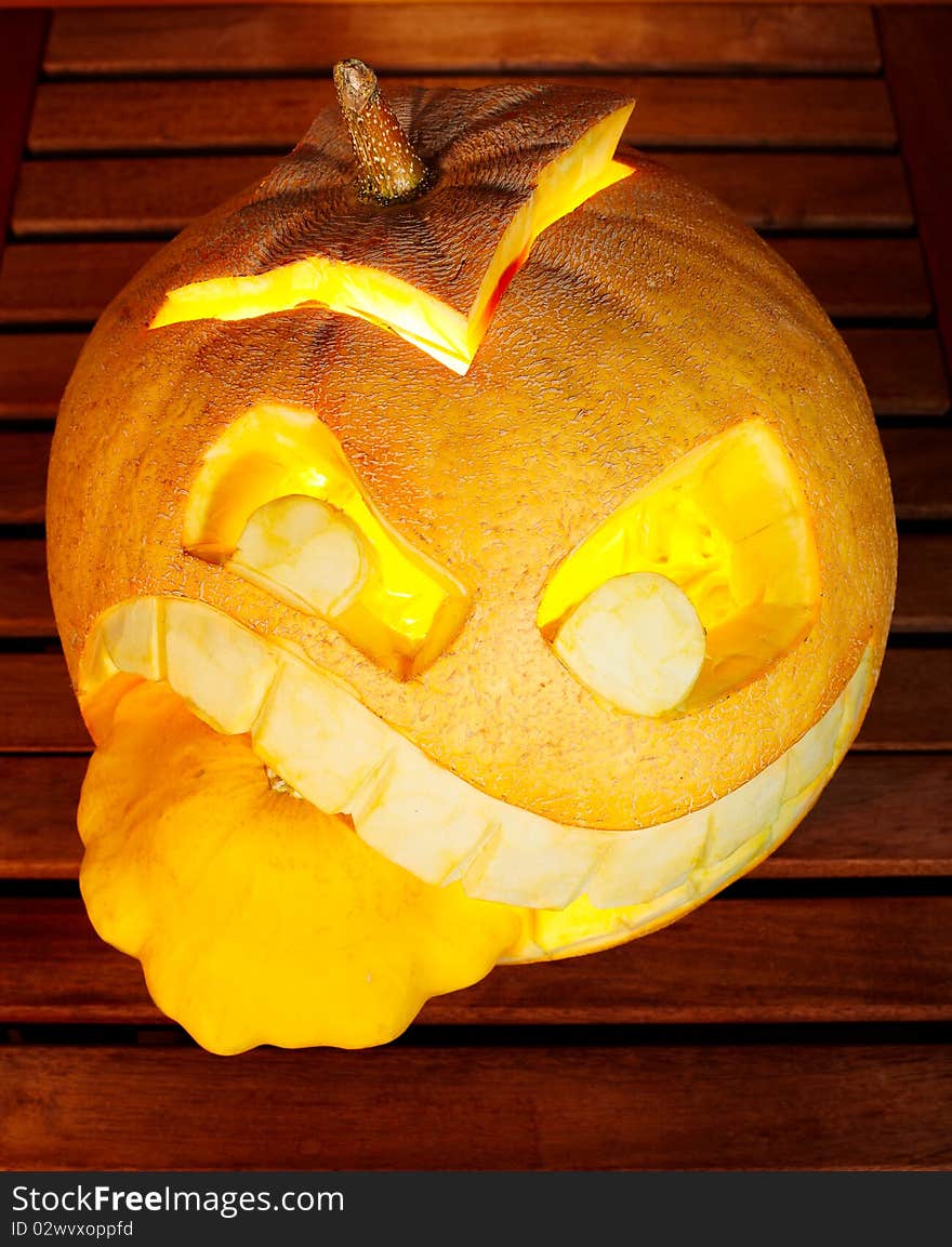 Studio shot of orange pumpkin eating another pumpkin