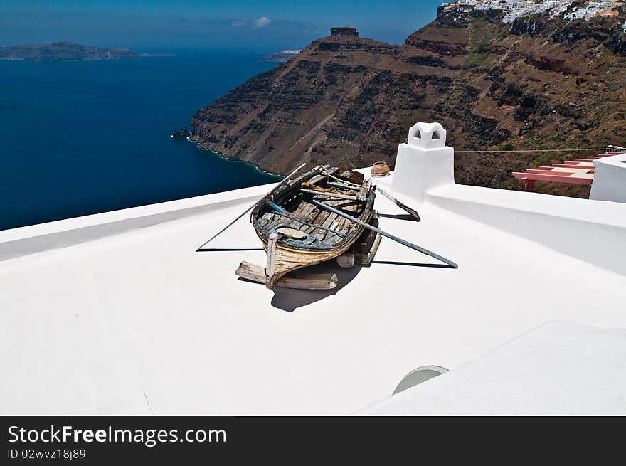 An old boat lying on a roof above the sea. An old boat lying on a roof above the sea.