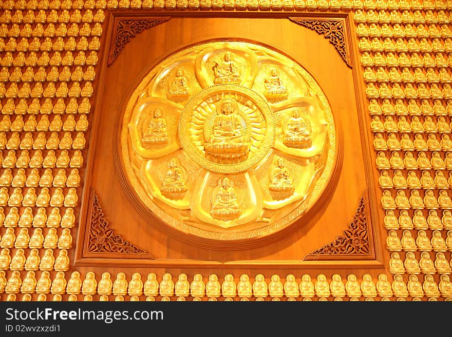 Golden buddha on wooden wall