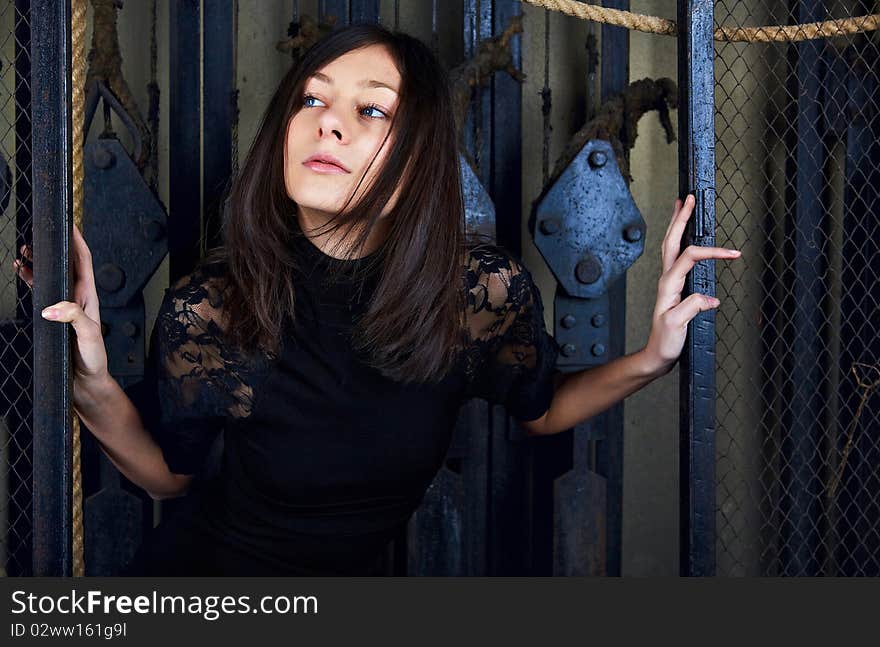 Portrait brunet female with blue eyes on industrial background