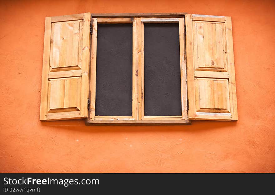 Vintage wooden window on orange wall. Vintage wooden window on orange wall