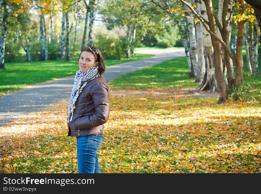 Portrait of a young beautiful woman on autumn walk