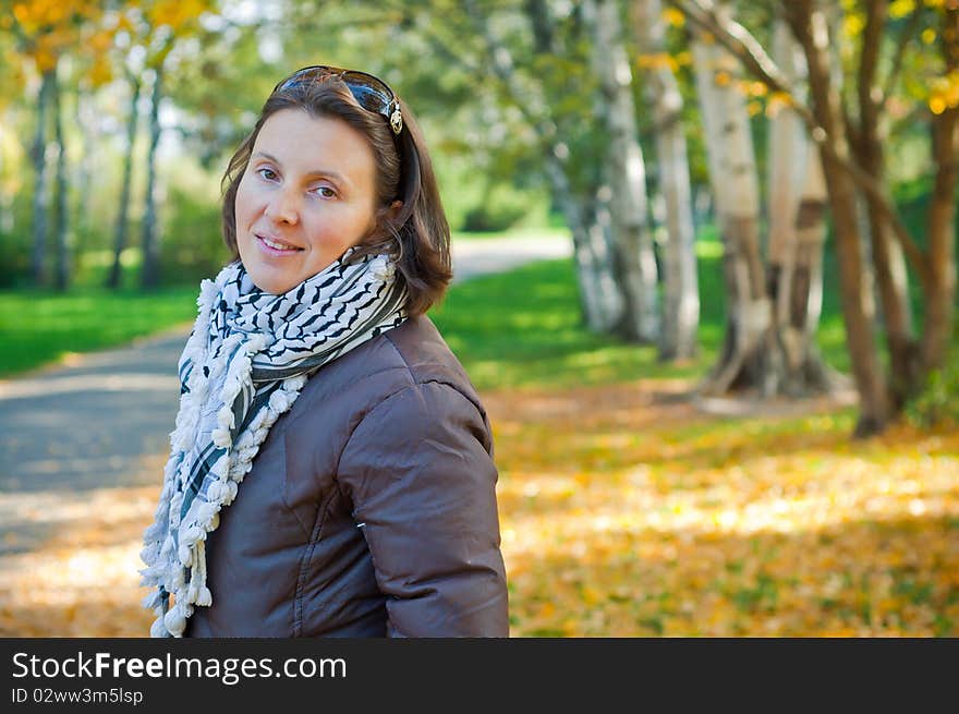 Portrait of a young beautiful woman on autumn walk