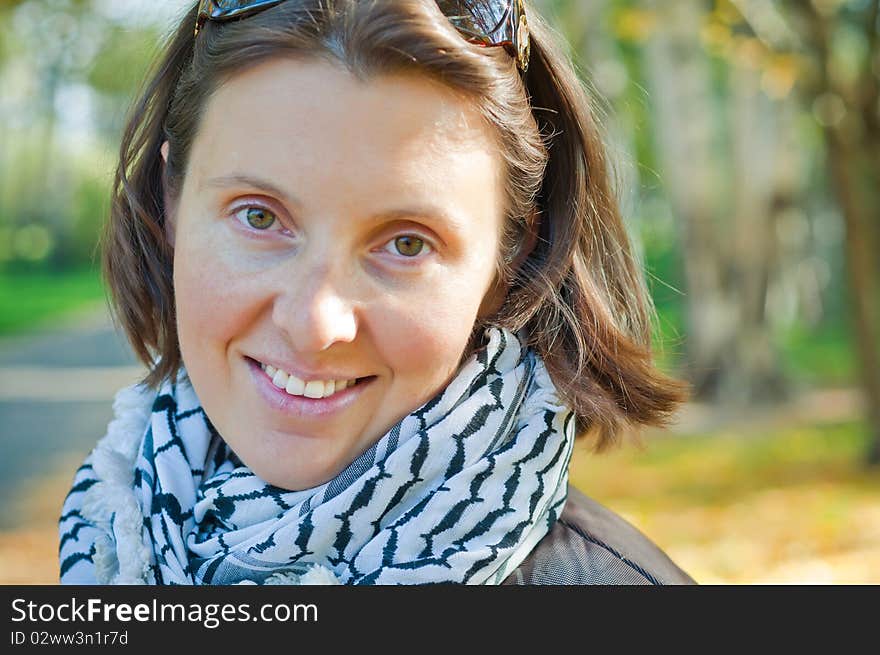 Portrait of a young beautiful woman on autumn walk