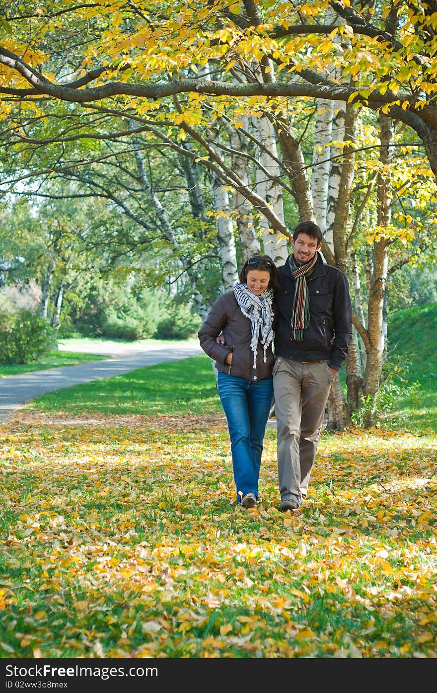 Romantic young beautiful couple on autumn walk