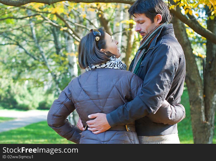 Romantic young beautiful couple on autumn walk