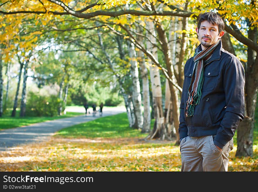 Portrait of a young beautiful man on autumn walk