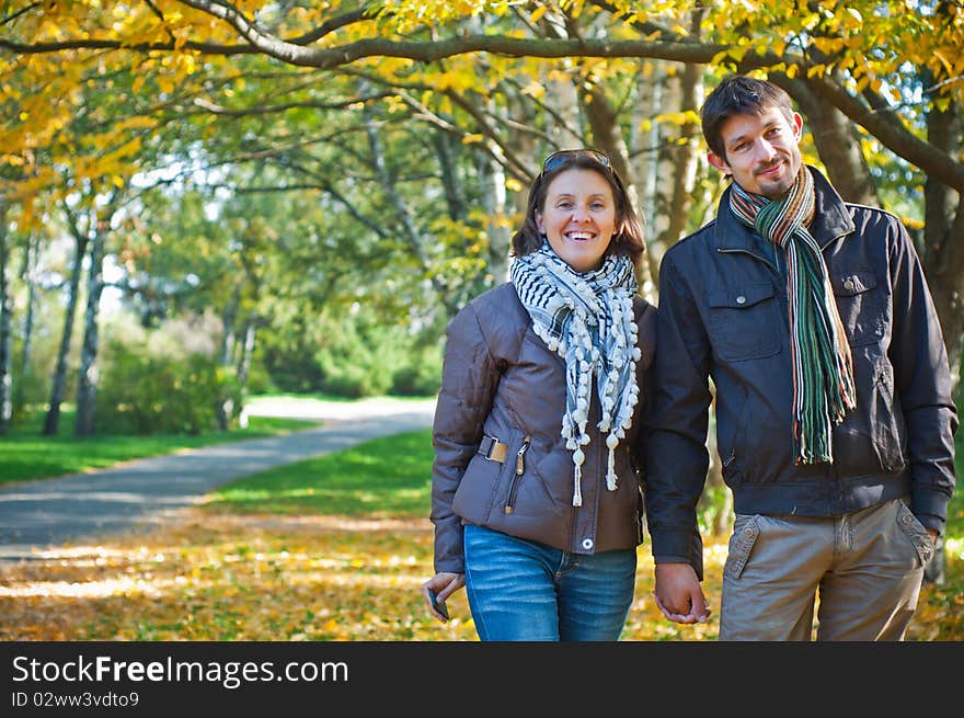 Romantic young beautiful couple on autumn walk