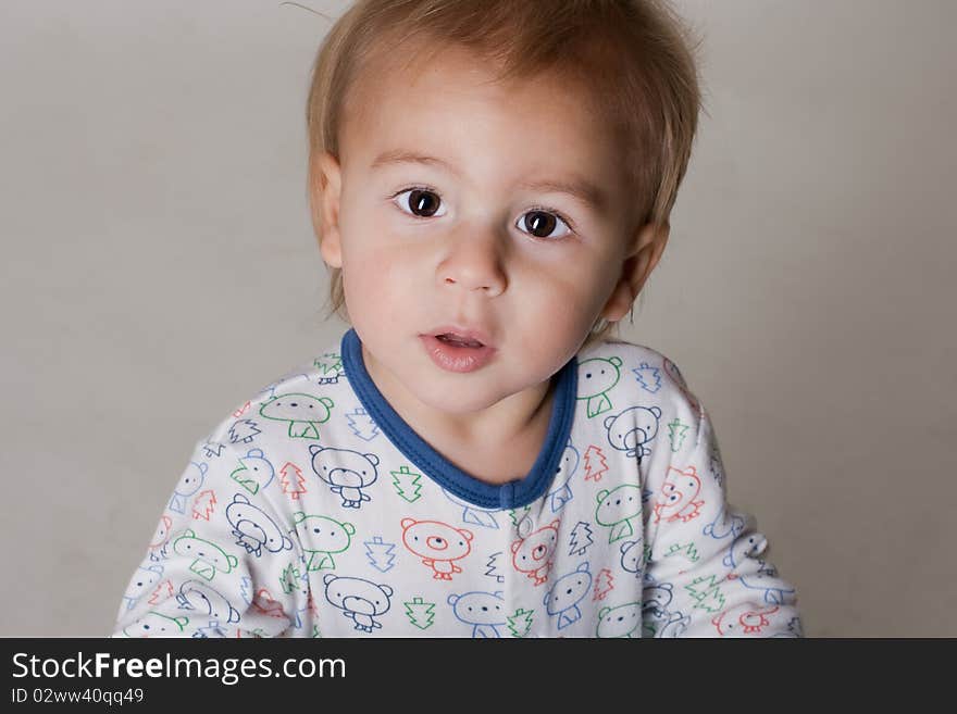 Portrait of a beautiful little boy with big eyes in a sleepwear