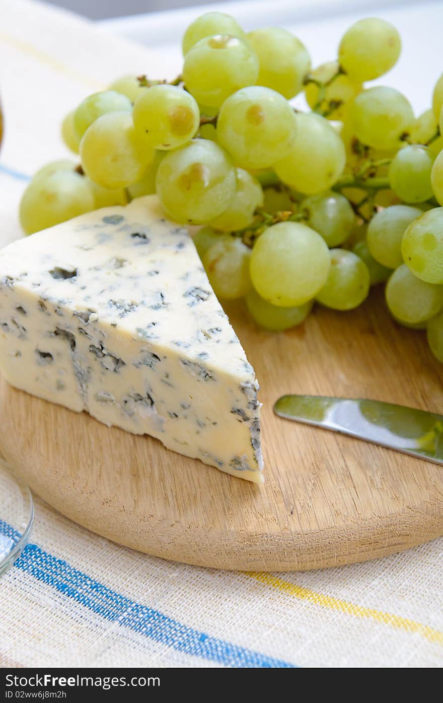 Grapes and blue cheese on a board