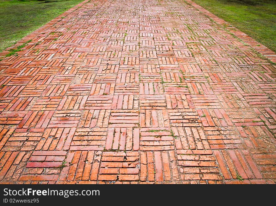 Vintage brick pathway on the green field