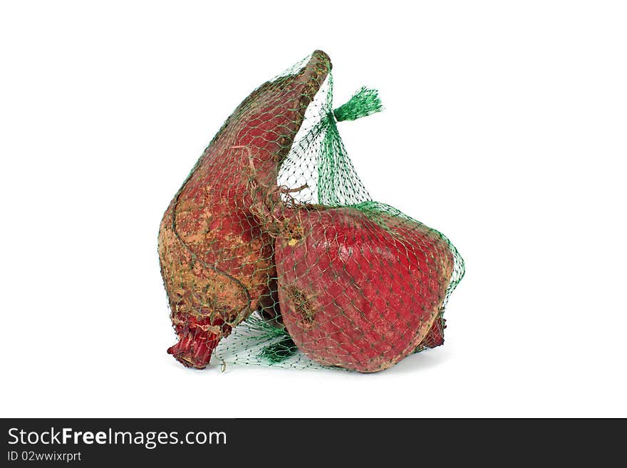 Red beet in plastic net isolated on white