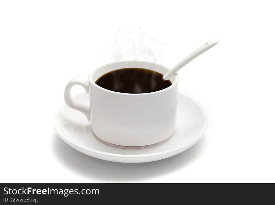 White coffee cup with a spoon on the saucer isolated on white background