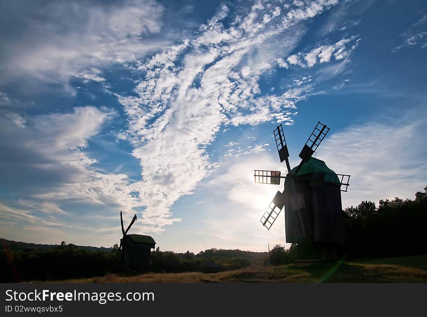 Landscape with a windmill against the blue sky