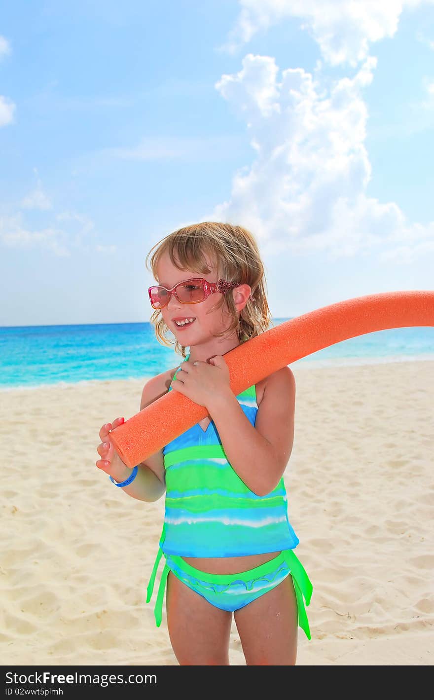 Little girl prepare to swimming in the ocean on nice summer day. Little girl prepare to swimming in the ocean on nice summer day.