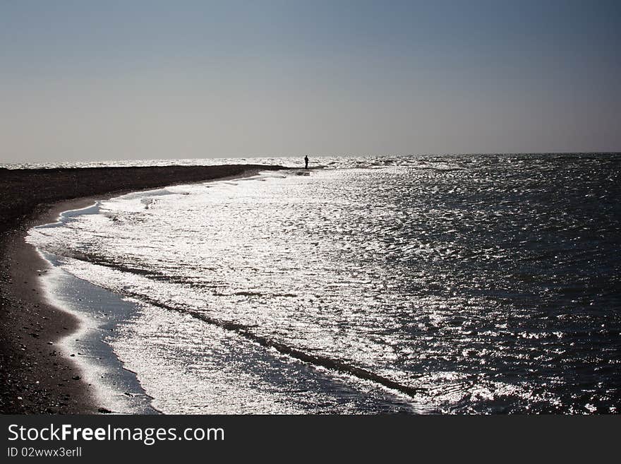 The fisherman fishes on the sea