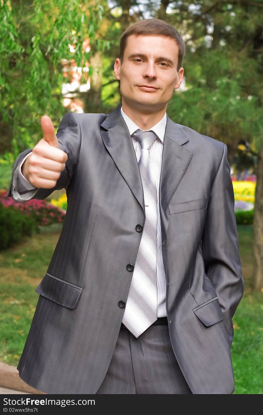 Young businessman with thumb up