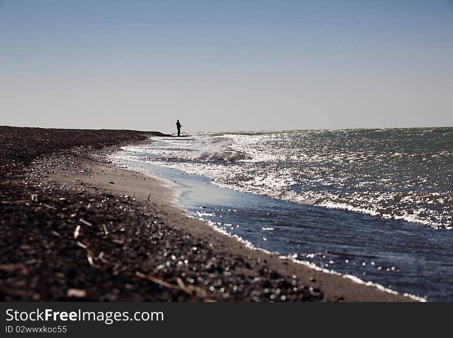 The fisherman fishes on the sea