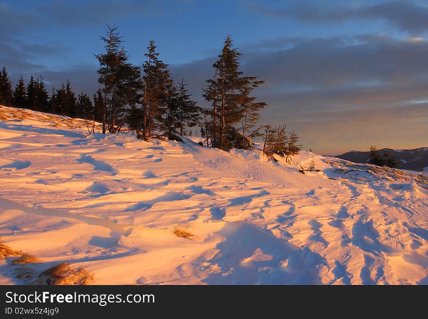 Winter landscape with mountains under evening sky with clouds. Winter landscape with mountains under evening sky with clouds