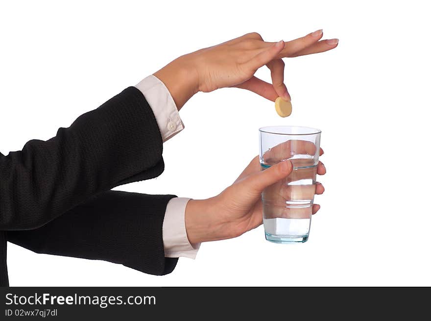 Businesswoman throws a pill from headache to the glass with water. Businesswoman throws a pill from headache to the glass with water