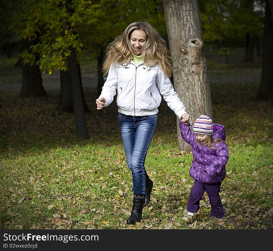 Mom and daughter running in the park