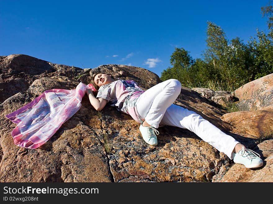 Happy brunette playing with a scarf in the summer