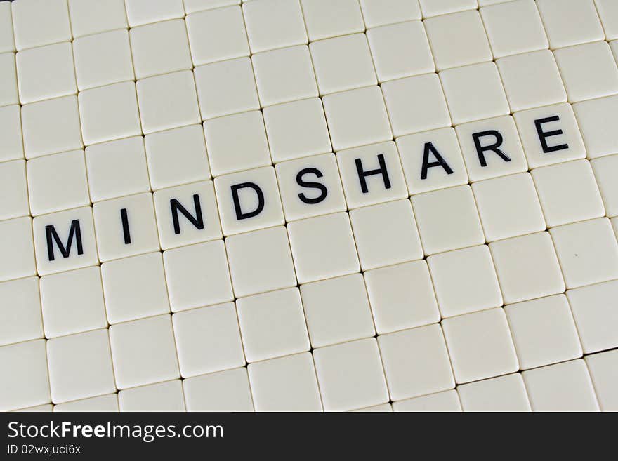 The word 'MIndshare' in tiles surrounded by blank tiles.