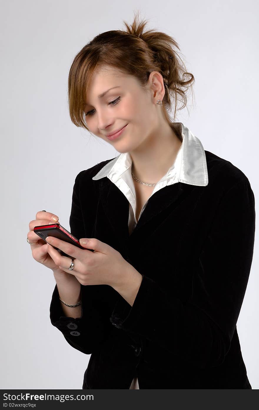 Businesswoman texting by phone, isolated on a white background