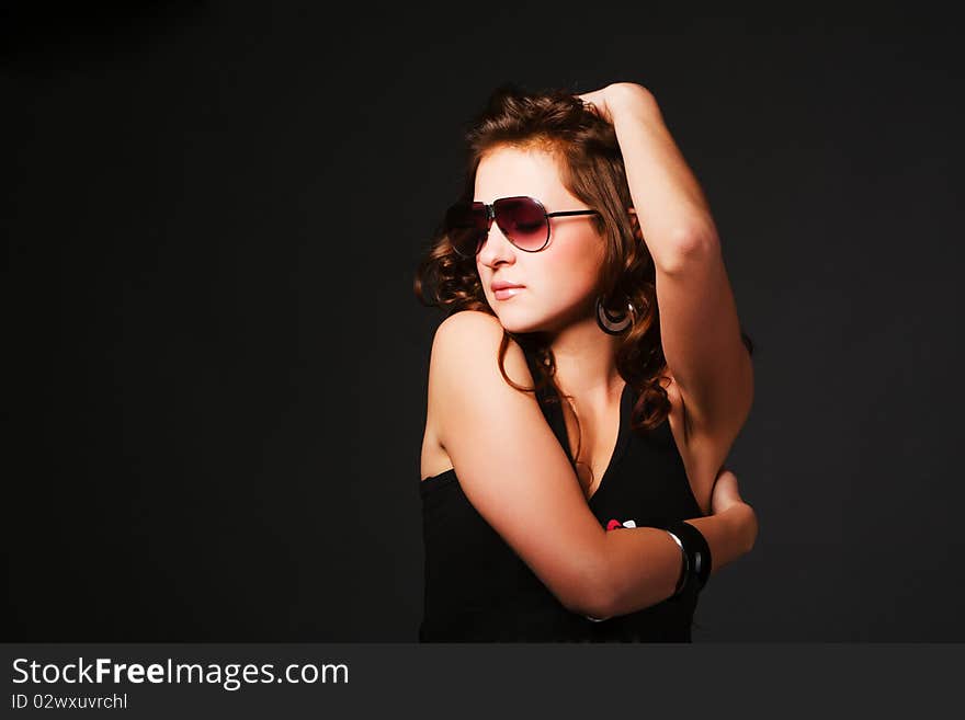 Curly beautiful young girl in sunglasses