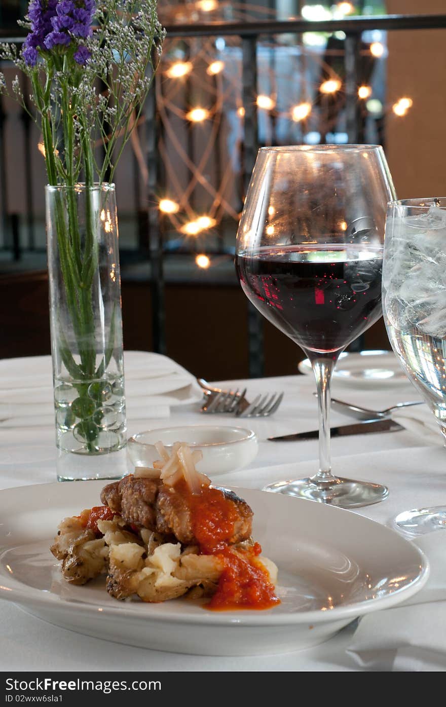 Grilled sweetbreads over potatoes with red sauce