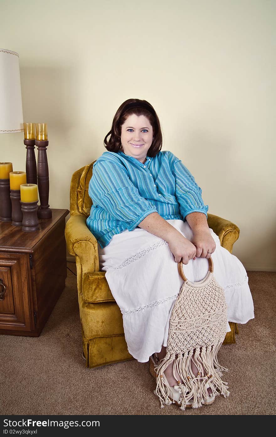 Woman in her early 40's sitting in a 1970's style home, wearing 1970's style clothing and macrame purse. Woman in her early 40's sitting in a 1970's style home, wearing 1970's style clothing and macrame purse.