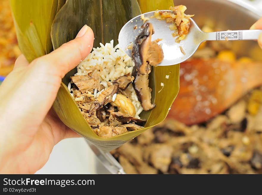 Closeup of dumpling making process where meat fillings are added. Asian style traditional cuisine.