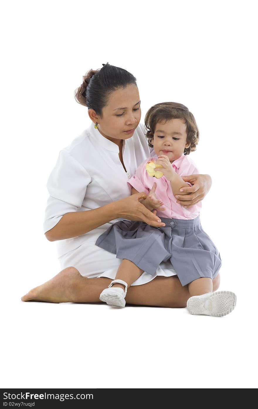 Mother with cute daughter eating an apple isolated on white background