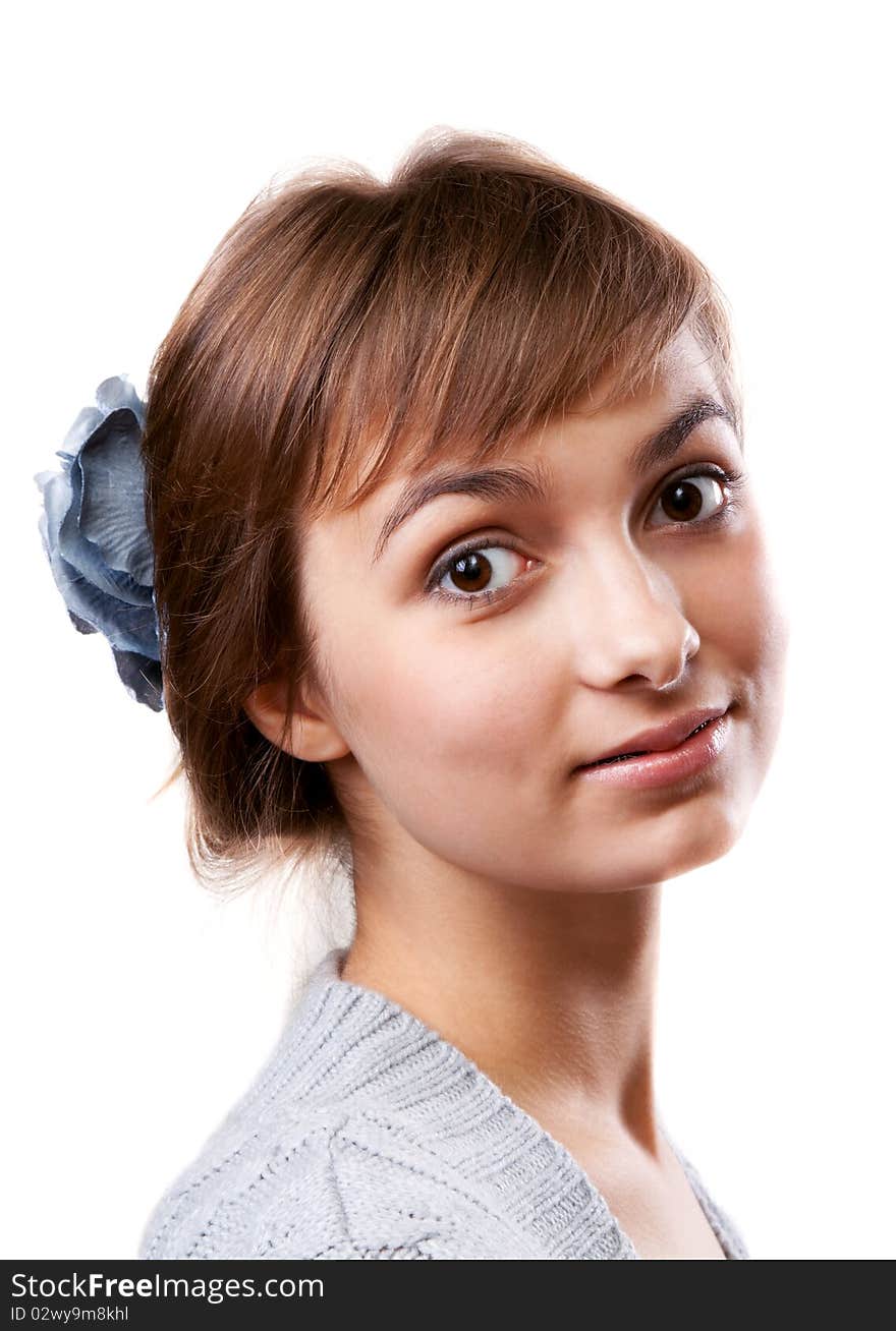 Portrait of the young girl in flower in hair on white background