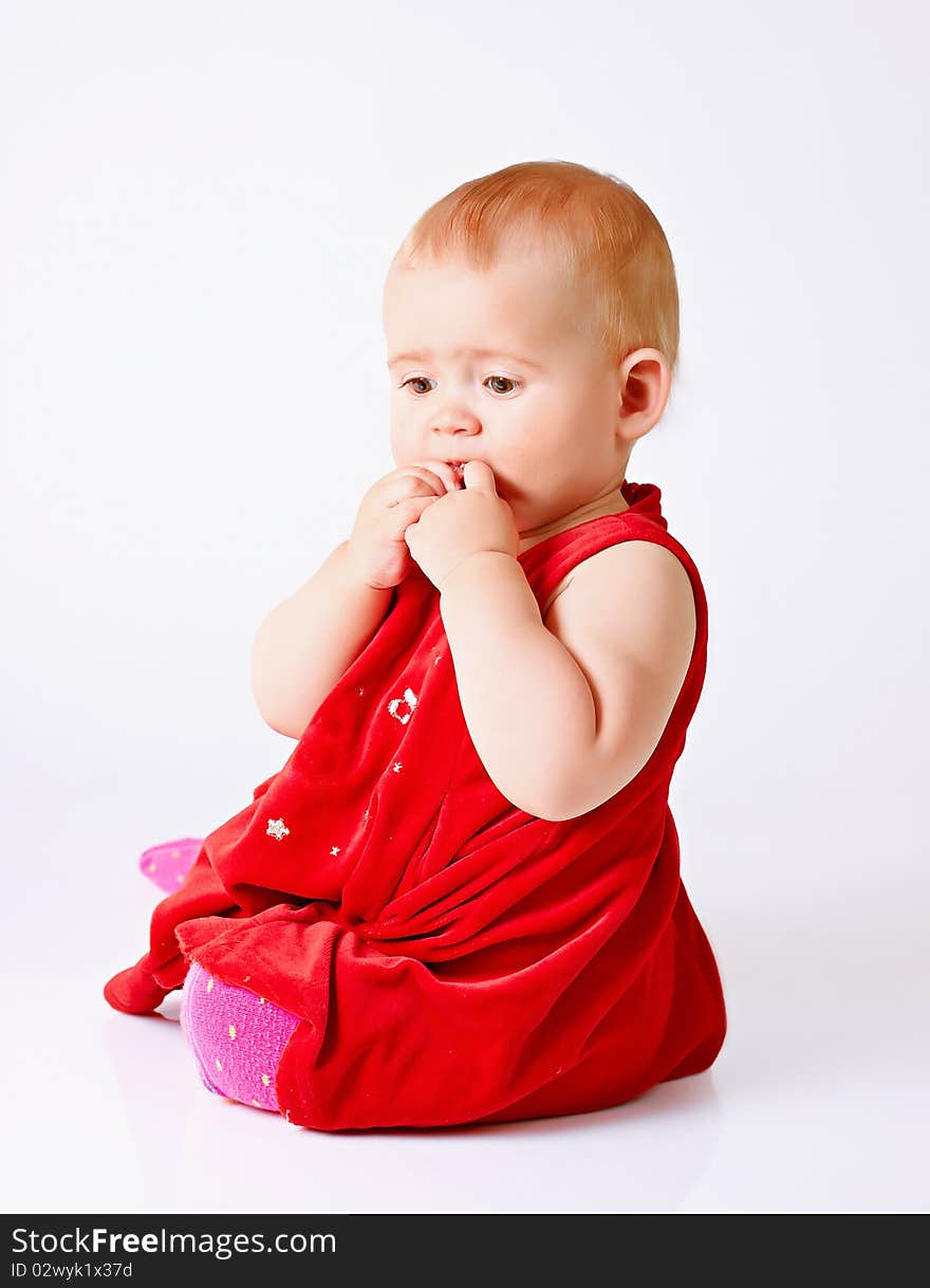 Little girl in red dress on white background