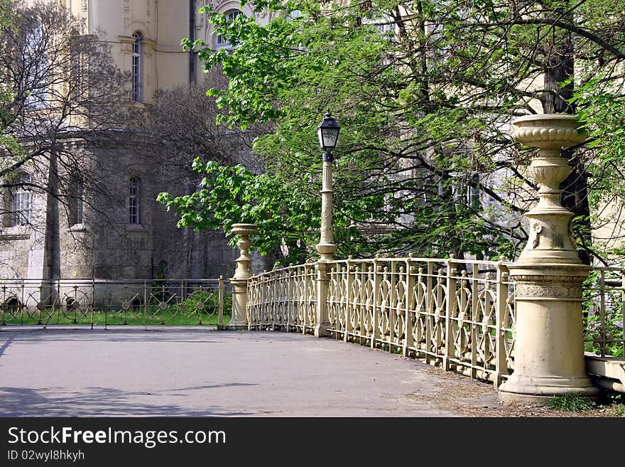 Asphalt road across the bridge in a city park in Budapest